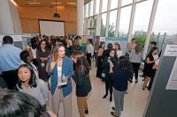 Meeting room filled with professionals and research posters